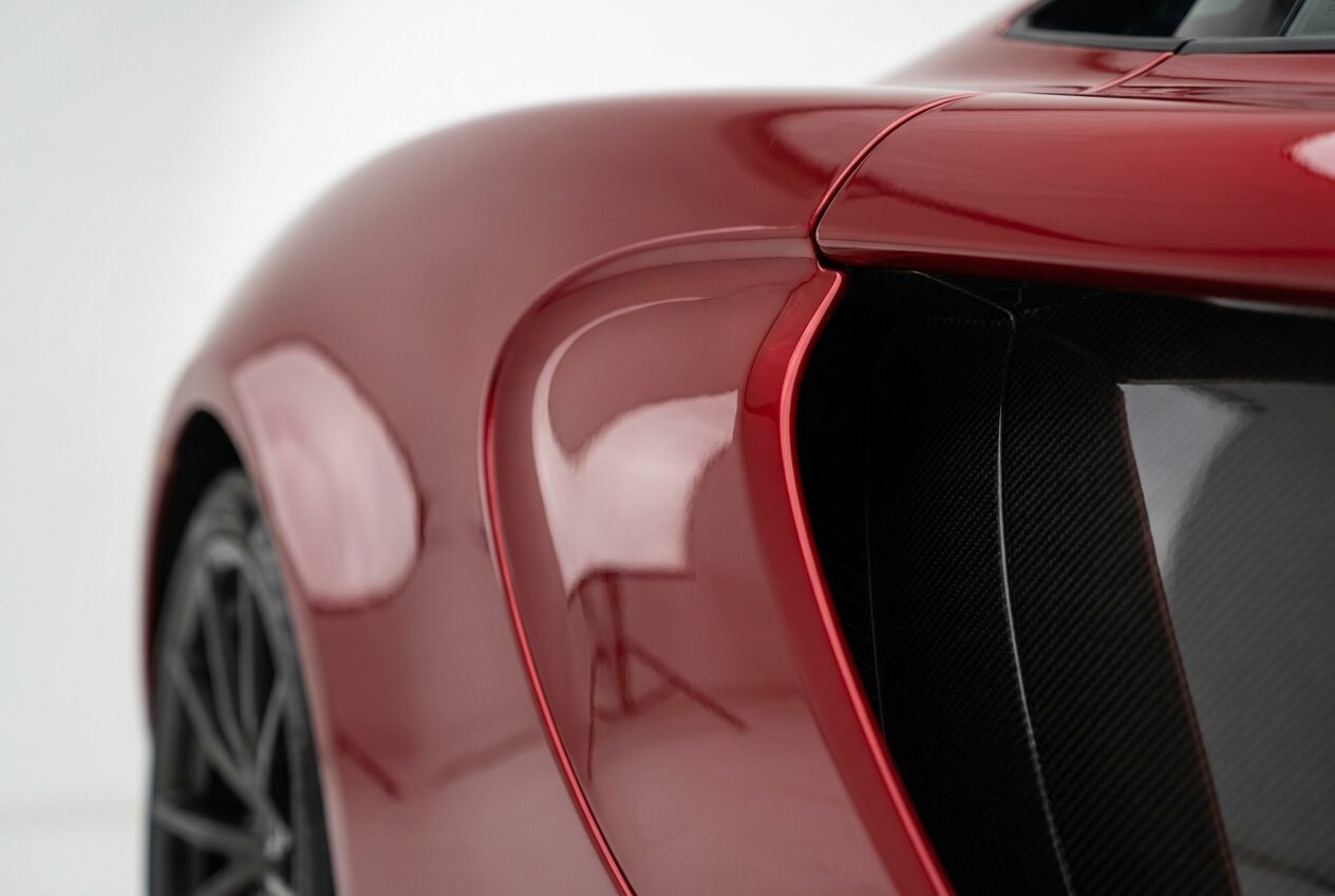 Close view of the rear haunch and side air intake in deep red paint