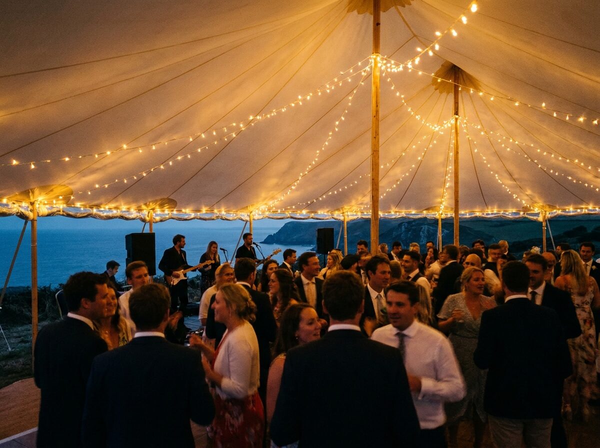 Guests dancing in the marquee under festoon lights
