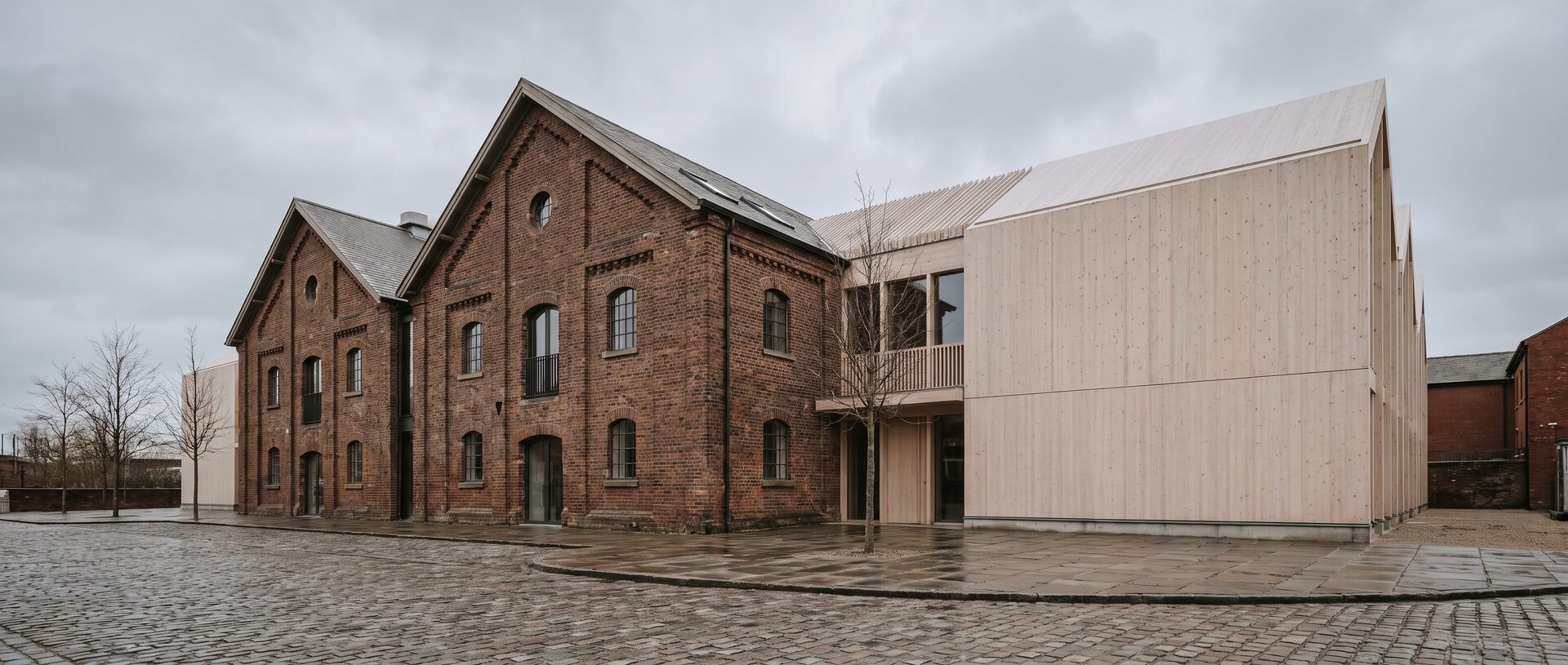 The Malthouse — timber extension against the listed brick shell