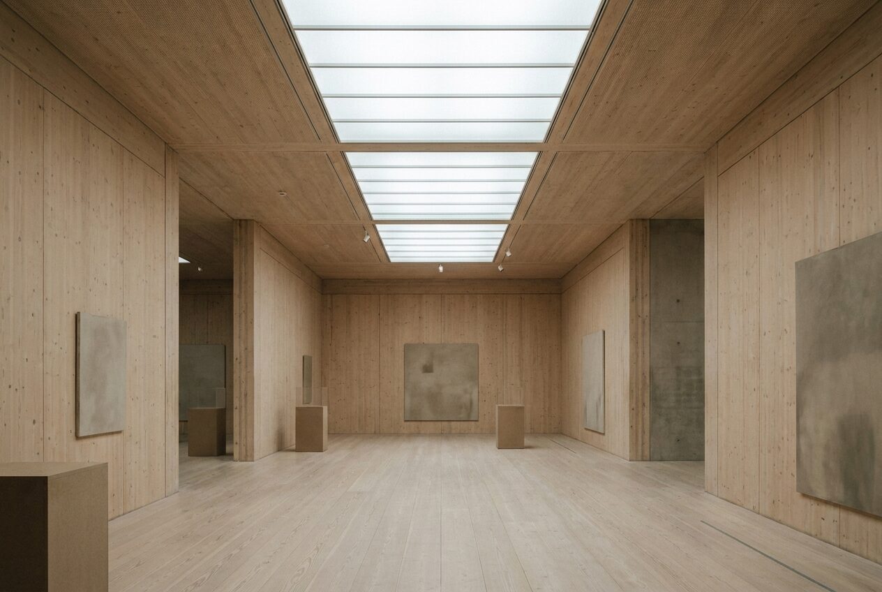 Gallery interior — exposed cross-laminated timber under an even rooflight